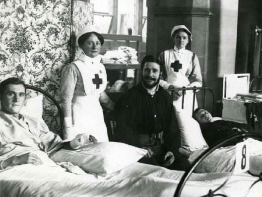 Soldiers in hospital being looked after by two nurses